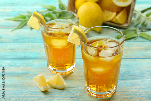 Glasses of ice lemon tea on wooden table