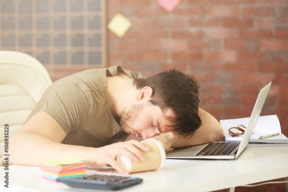 Young man sleeping at the working place. Young man sleeping at the working place.