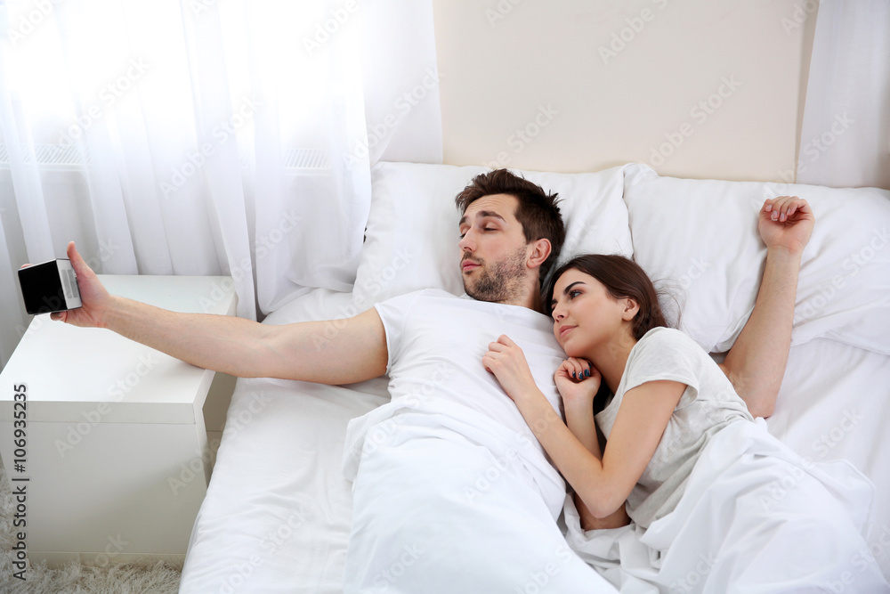 Fototapeta premium Young cute couple waking up after a night sleep.