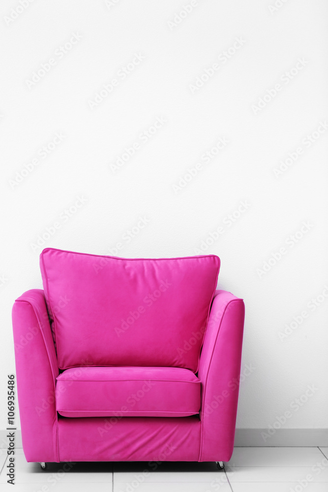 Pink armchair on white wall background Pink armchair on white wall background