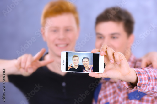 Two teenager boys making ph...