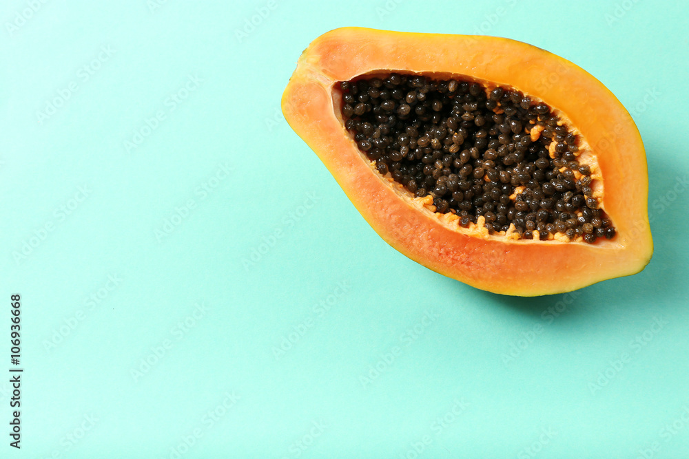 Halved papaya on blue background Halved papaya on blue background