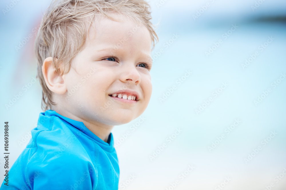 Little boy looking at something with interest on the beach Little boy looking at something with interest on the beach