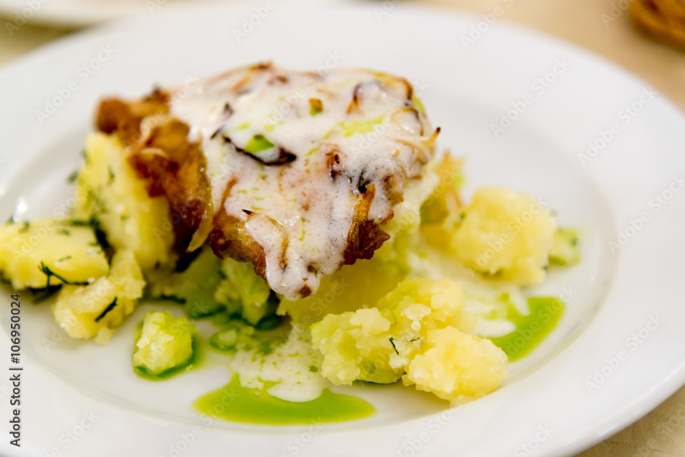 Boiled potatoes and cod in batter