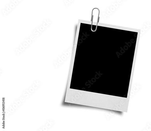close up of a paper clip and old photo frame on white background