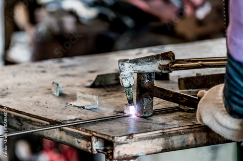 HDR image of a technician using welder in factory's workshop