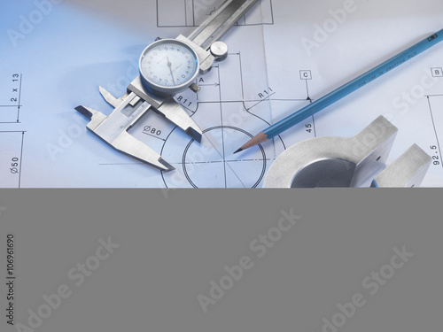 Engineering drawing with product, micrometer and calipers