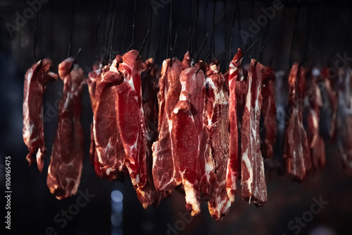 Tableau sur toile meat in a smokehouse, the meat on hooks