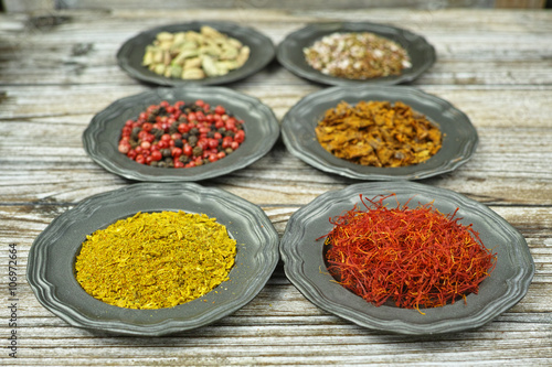 Spices and herbs in metal bowls. Food and cuisine ingredients.