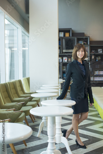 Attractive asian business woman smiling in workplace
