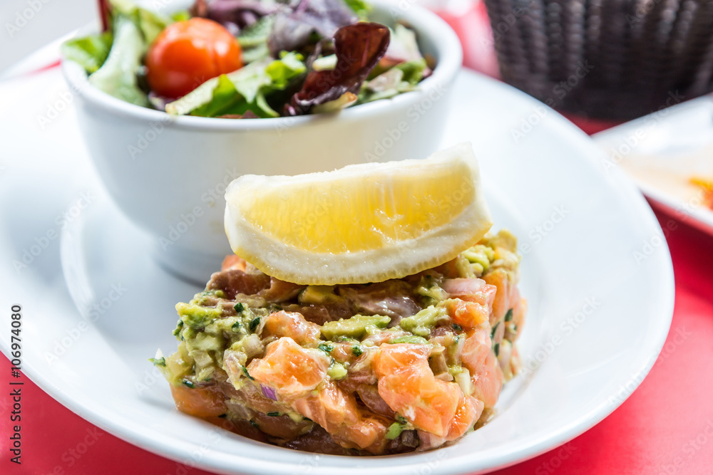 salmon and lemon - french cuisine dish with tomato and salmon salmon and lemon - french cuisine dish with tomato and salmon