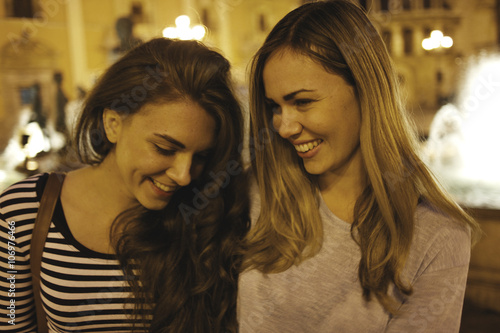 Two young women tourists, Plaza de la Virgen, Valencia, Spain photo