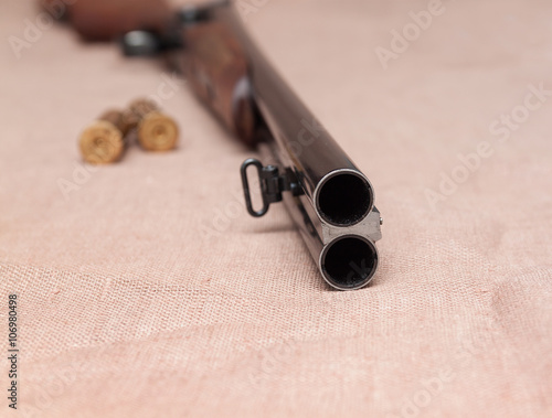 Canvas Print double-barrelled gun with bullets on white background