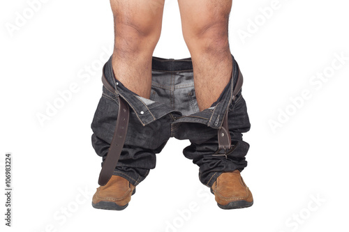 closeup of a young Asian man with his denim pants down, seen from front view on white background