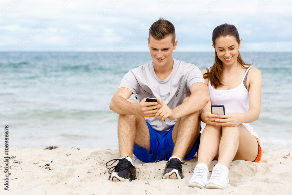 Couple of runners with mobile smart phones outdoors StockFoto Adobe