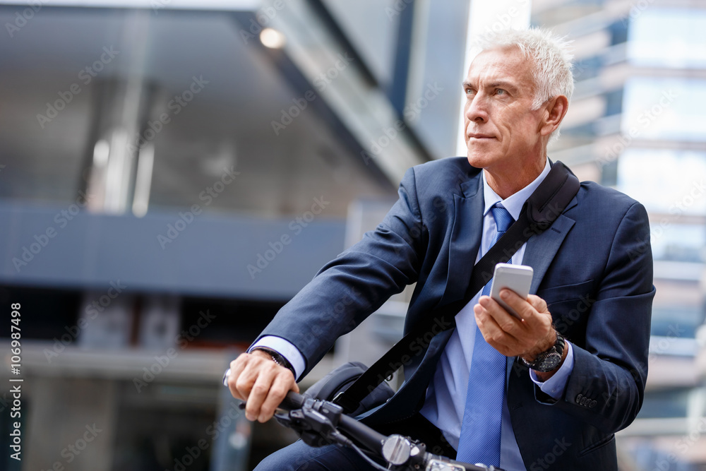 Successful businessman riding bicycle Successful businessman riding bicycle
