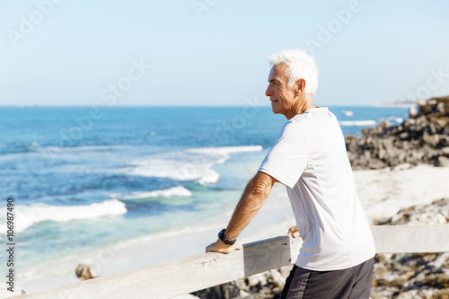 Man standing on beach in sports wear