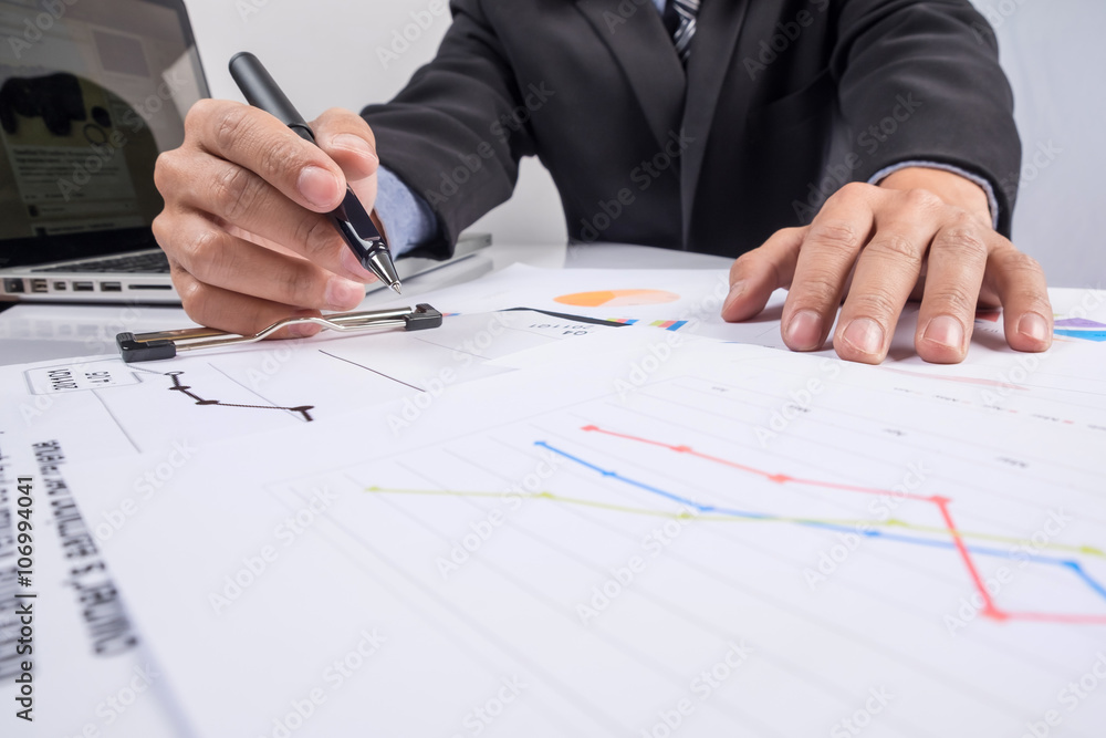 Business people discussing financial charts - closeup shot of ha Business people discussing financial charts - closeup shot of ha