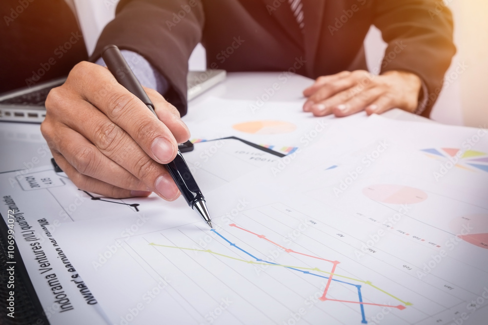 Business people discussing financial charts - closeup shot of ha Business people discussing financial charts - closeup shot of ha