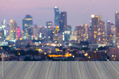 Opening wooden floor, Abstract blurred bokeh city lights downtown background © pranodhm