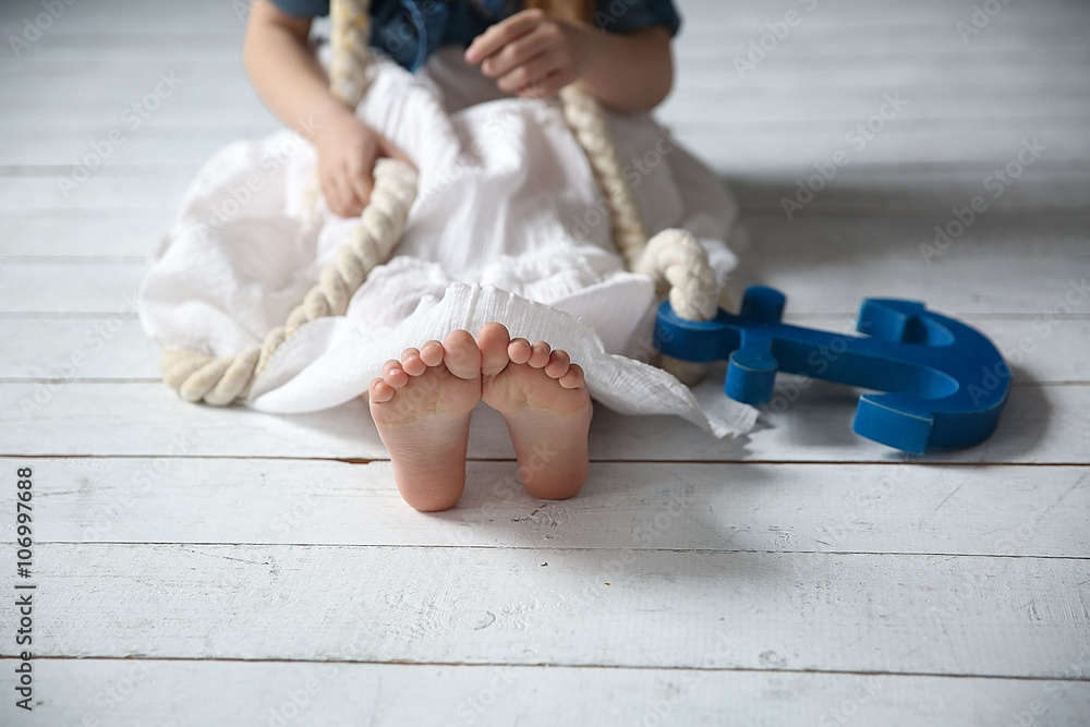 Little girl with rope and anchor in her hands Stock Photo | Adobe Stock