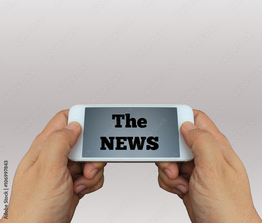 a man using hand holding the smartphone with text The News on di a man using hand holding the smartphone with text The News on di