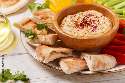 Vászonkép Homemade hummus with assorted fresh vegetables and pita bread.