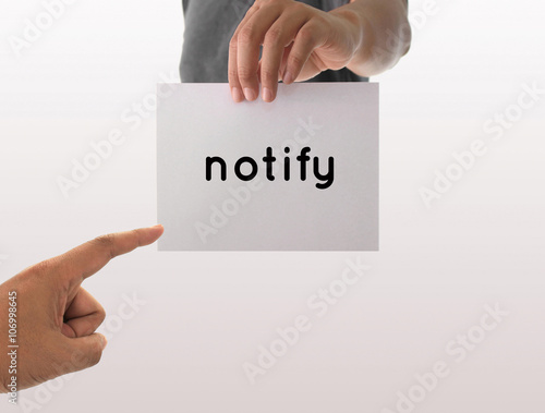 a man using hand holding the white paper with text notify