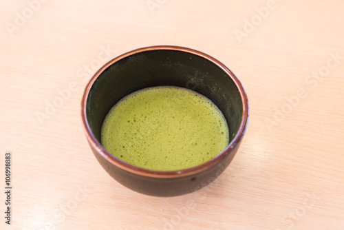 fresh green tea in traditional cup