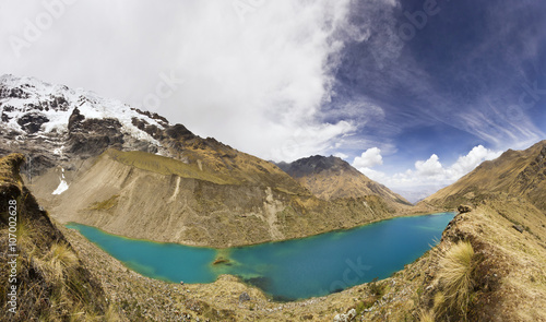 panorama of snow-covered Andes mountains and blue lake © sergeyonas