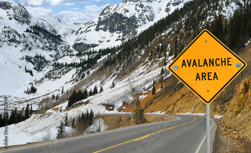Canvas-taulu Avalanche and Sign: A sign warns motorists in an area of southwest Colorado where an avalanche has recently covered the road