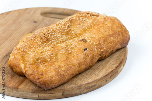 Fresh puff pastry on the wooden board, isolated on white