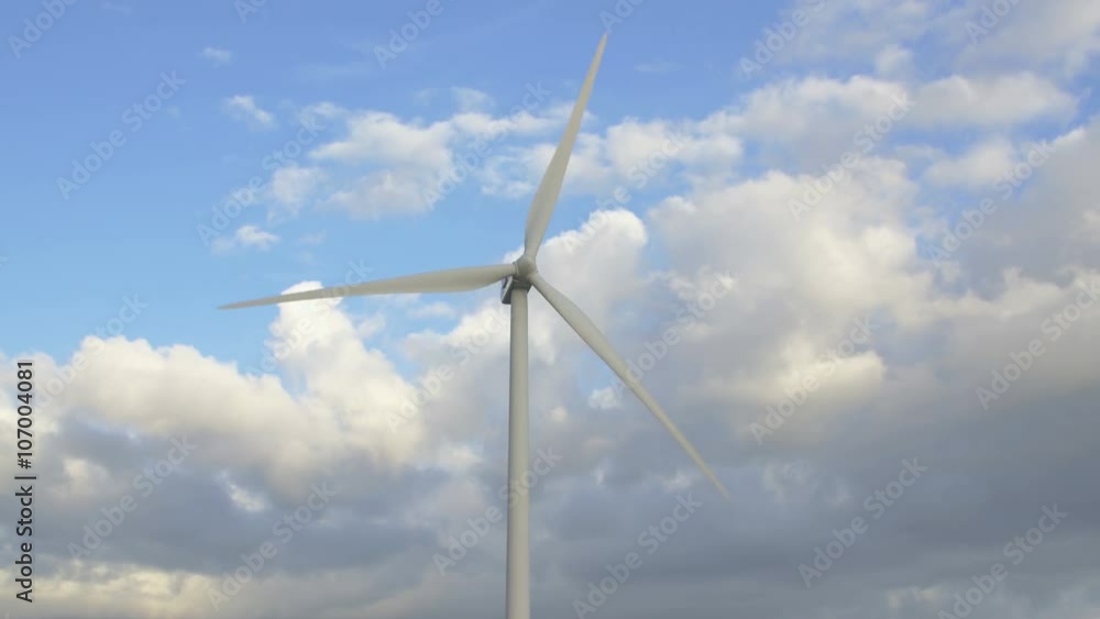 wind turbines from the front. In the background are clouds and blue sky. wind turbines from the front. In the background are clouds and blue sky.