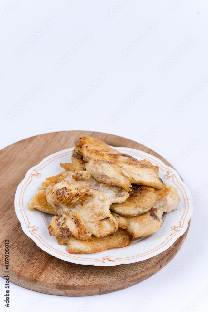 Grilled chicken breasts on the plate isolated over white Grilled chicken breasts on the plate isolated over white