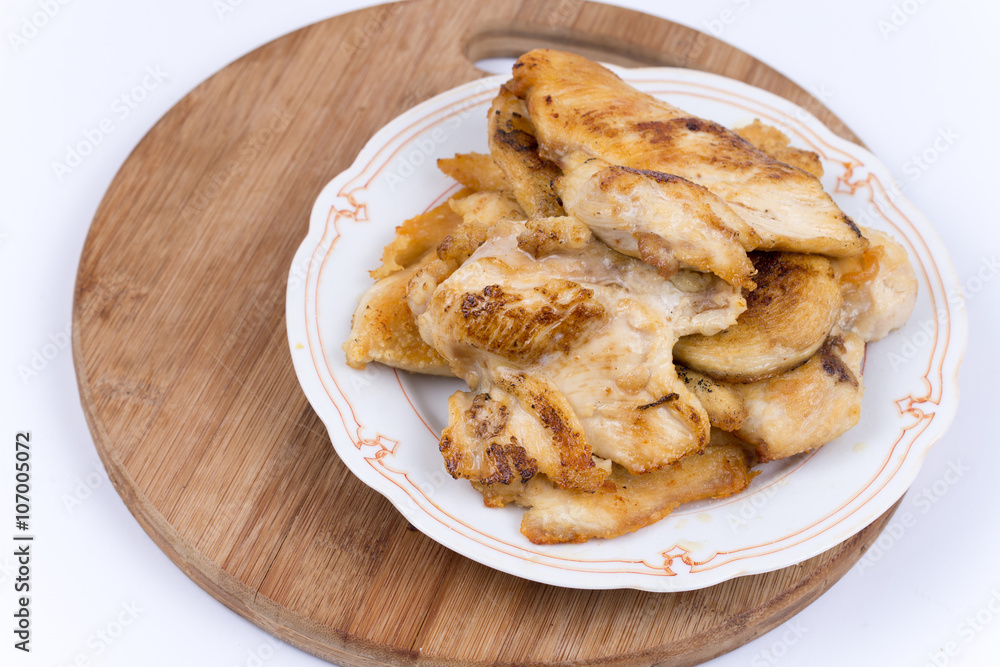 Grilled chicken breasts on the plate isolated over white Grilled chicken breasts on the plate isolated over white