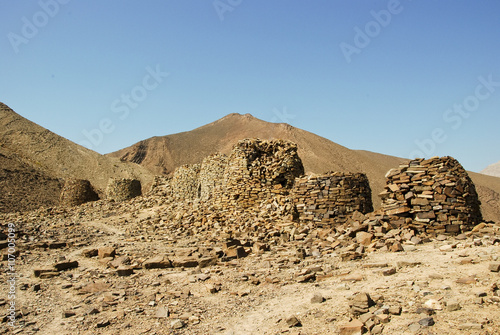 Lined up dramatically atop a rocky ridge  the Beehive Tombs of B