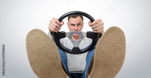 Man with a steering wheel, front view. Driver car concept