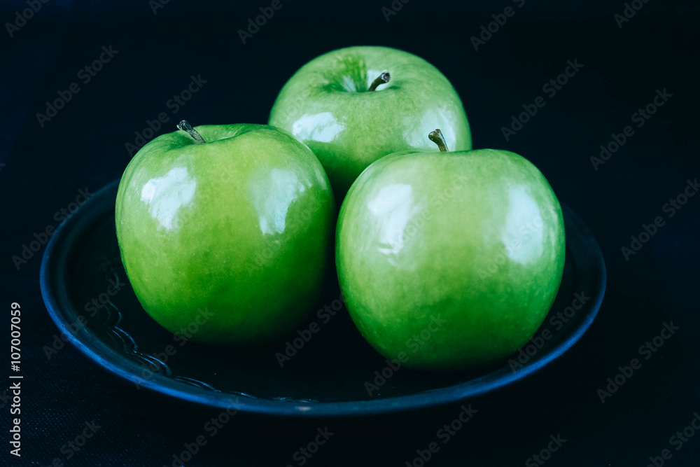 green apples on a black background