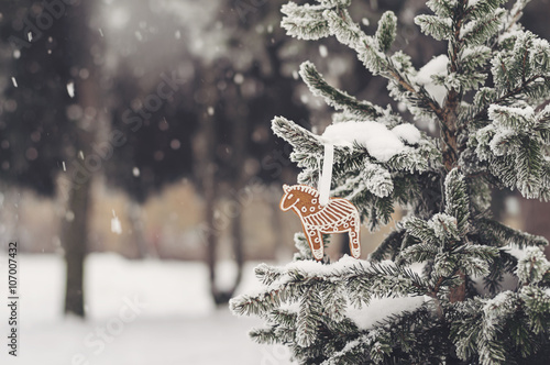snow-covered fir-tree with gingerbread cookie