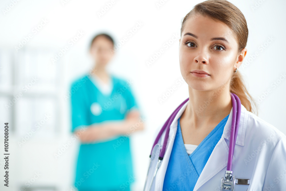 Woman doctor standing with folder at hospital Woman doctor standing with folder at hospital