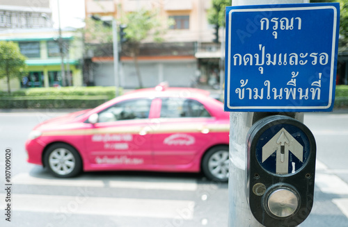 push button for Red traffic light in Thailand. thai language -- (Selective focus)