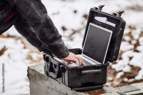 Opened plastic protector case with laptop lying   photo