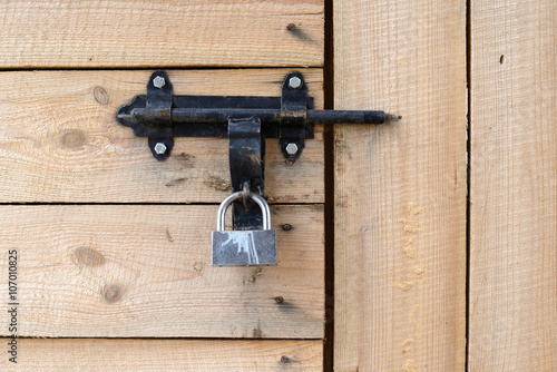 Padlock on the wooden door photo