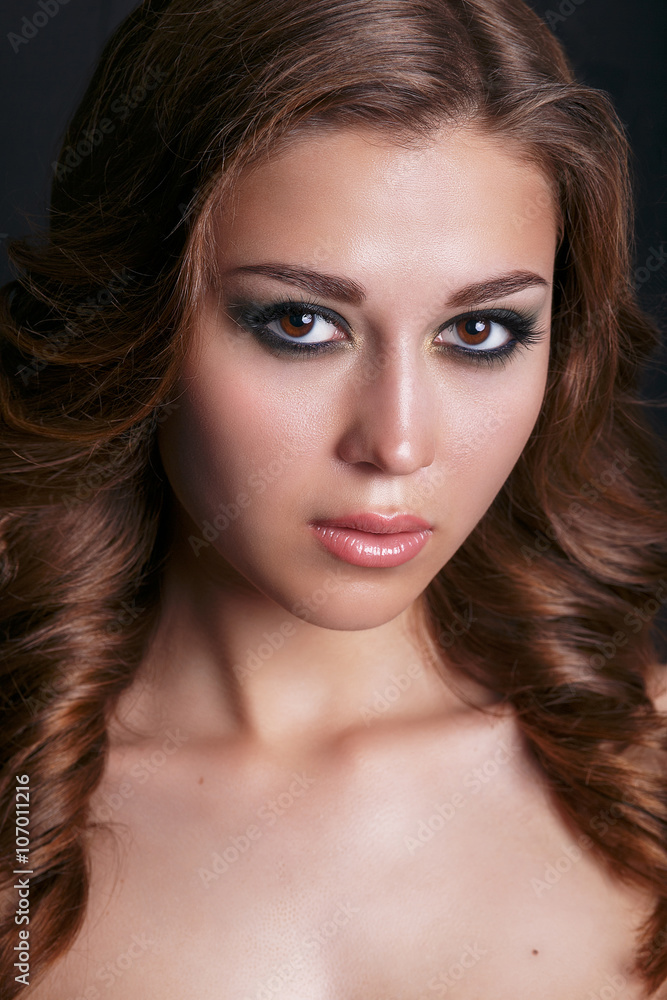 Fashion portrait of young beautiful sexy woman with long wavy hair. Beauty Model Woman with Long Brown Hair. Healthy Hair and Beautiful Professional Makeup. Smoky Eyes Make up. Gorgeous Woman Face Fashion portrait of young beautiful sexy woman with long wavy hair. Beauty Model Woman with Long Brown Hair. Healthy Hair and Beautiful Professional Makeup. Smoky Eyes Make up. Gorgeous Woman Face