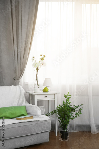 Grey sofa, small table and ...