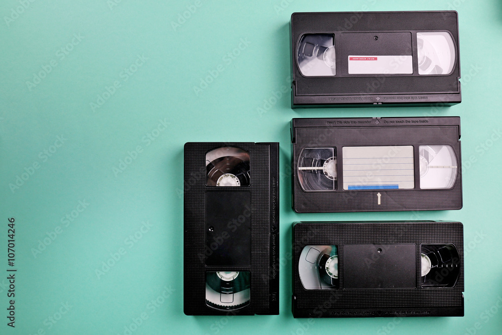 Fototapeta premium Set of old video cassettes on turquoise background