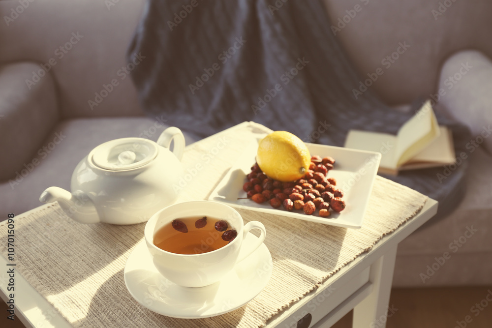 Rose hip and lemon tea on table in the room Rose hip and lemon tea on table in the room