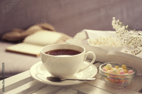 Cup of tea on coffee table in the room, close up