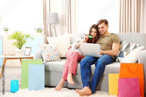 Young couple sitting on sof...