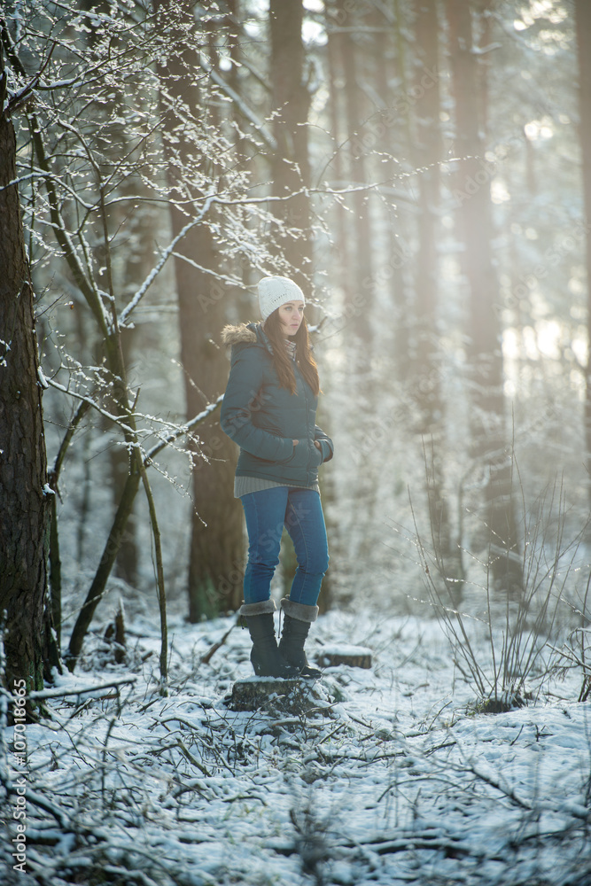 Young woman on a walk in snowy winter
